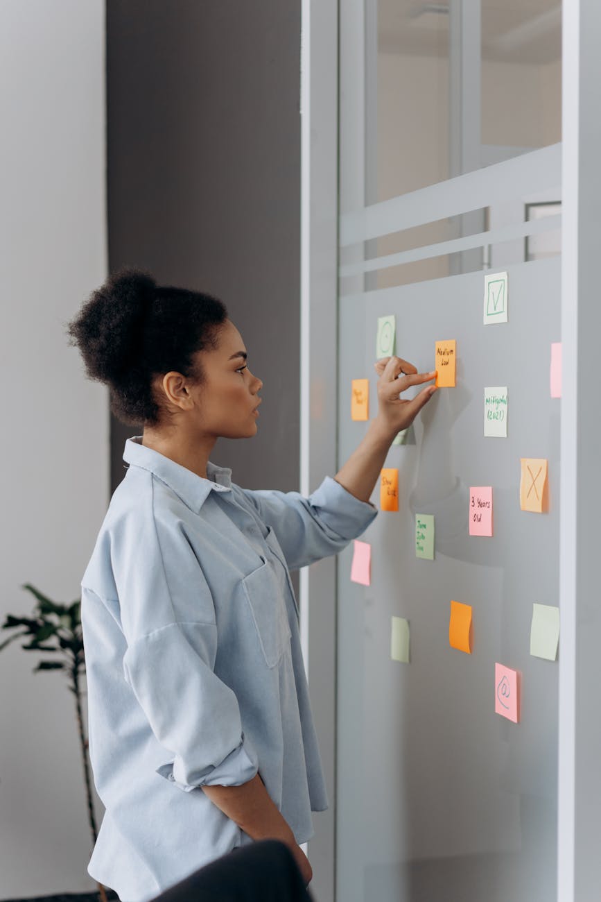 a woman looking at the sticky notes